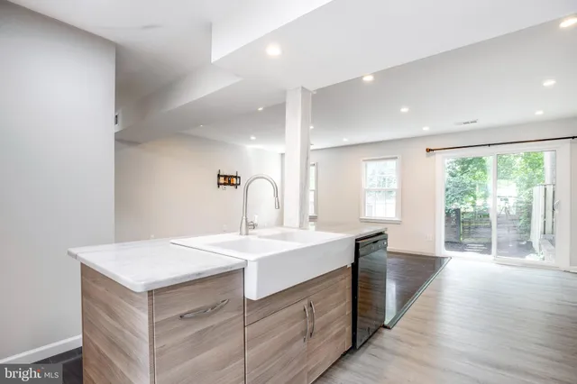 a kitchen with a sink stove and cabinets