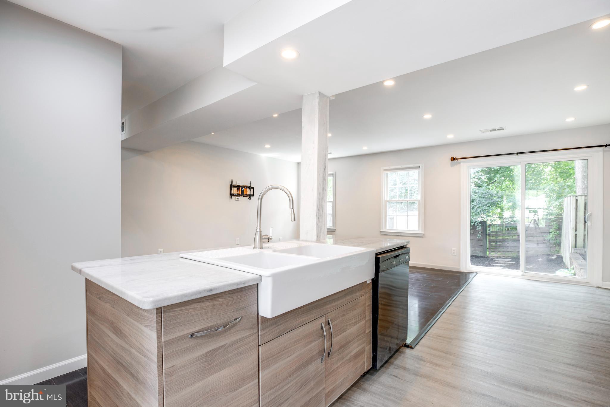 9513 Burdett Road Burke, VA 22015 - Photo 4 of 40 a kitchen with a sink stove and cabinets