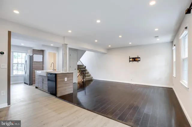 a view of kitchen with sink and wooden floor