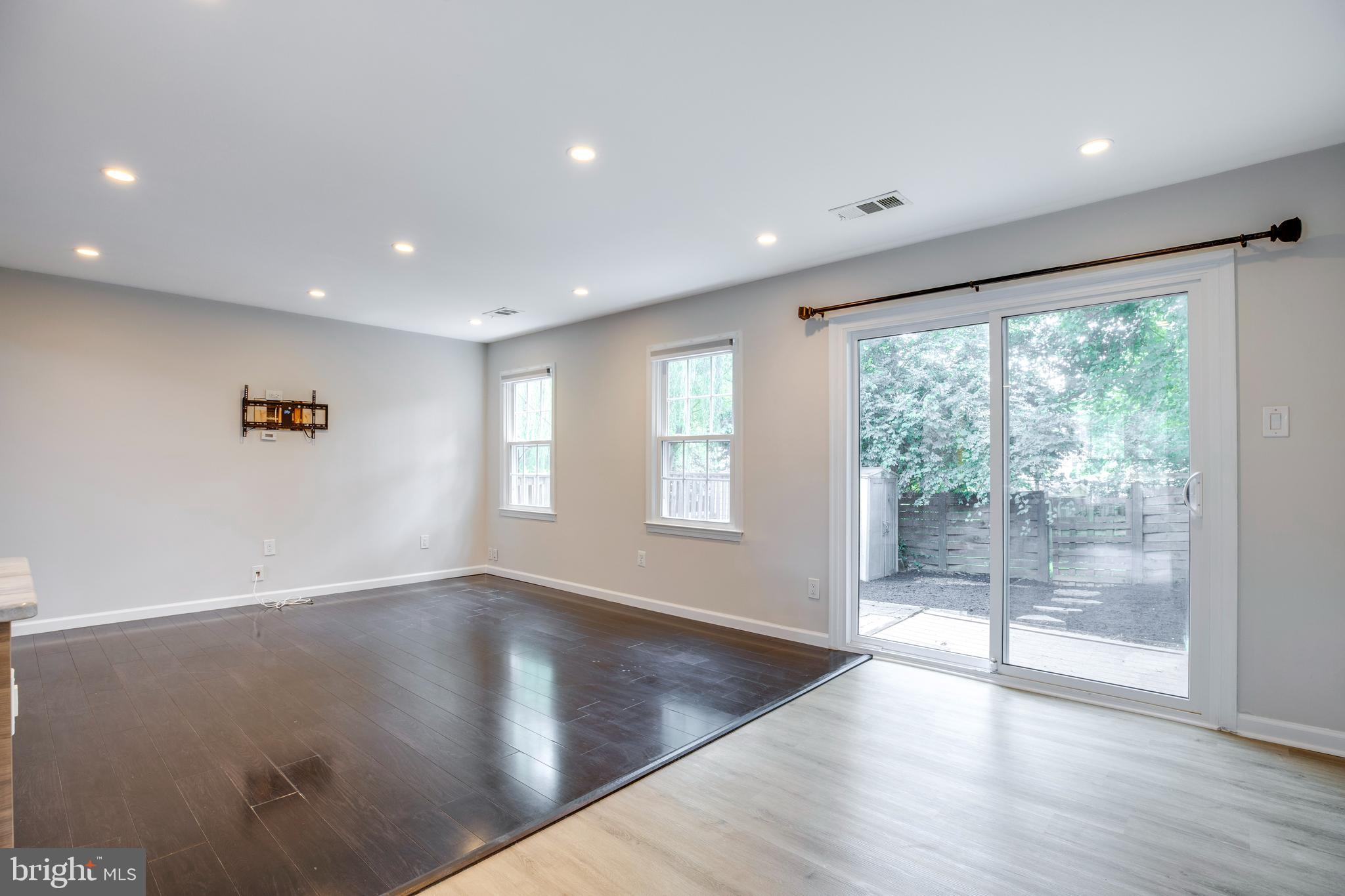 9513 Burdett Road Burke, VA 22015 - Photo 7 of 40 a view of empty room with wooden floor and fan