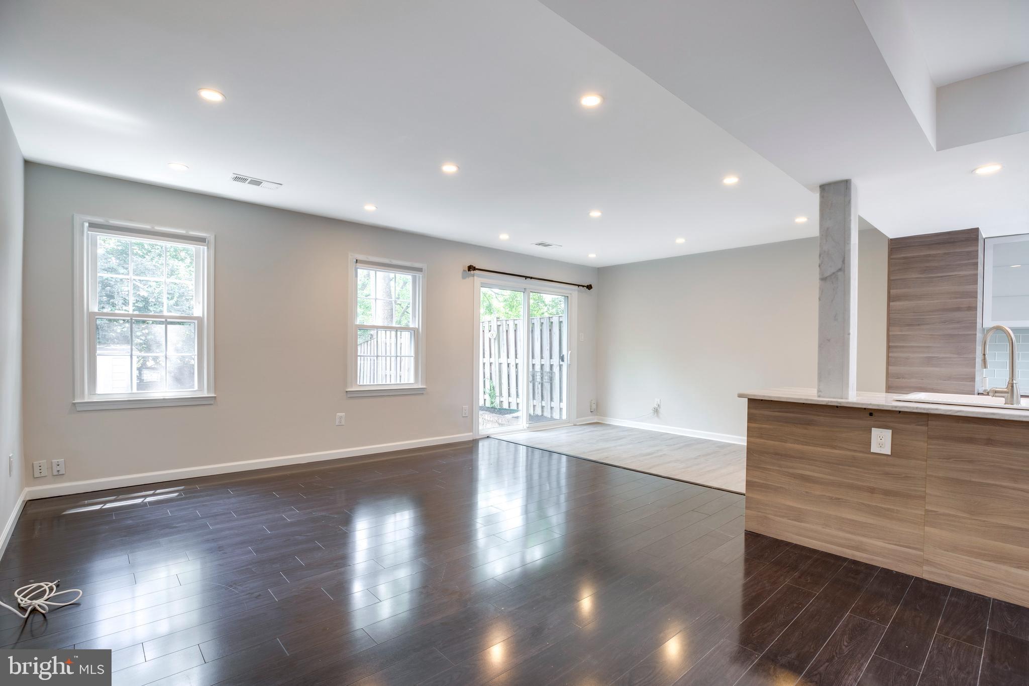 9513 Burdett Road Burke, VA 22015 - Photo 8 of 40 a view of an empty room with wooden floor and a window
