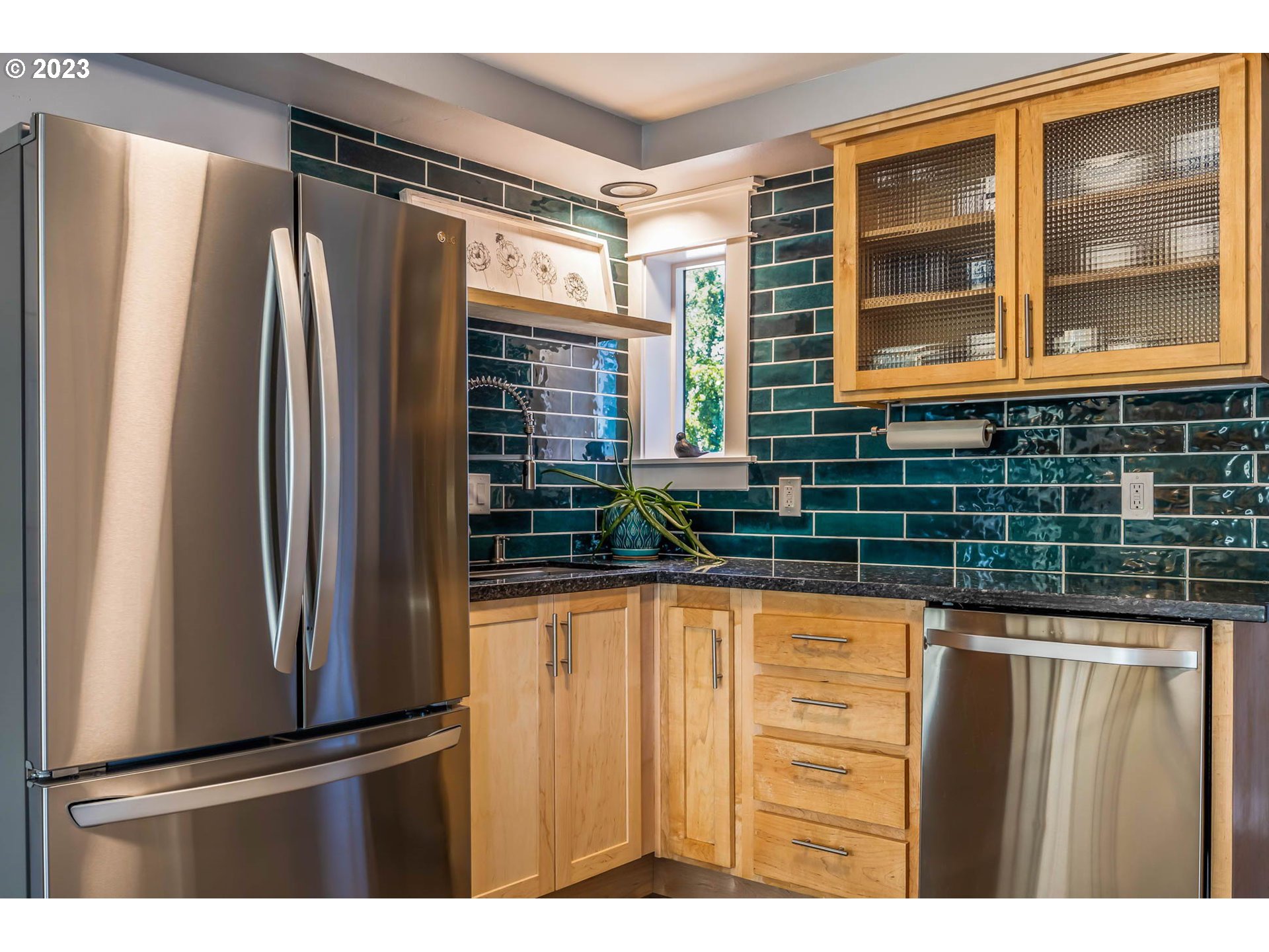 719 Janus Street Springfield, OR 97477 - Photo 3 of 48 a kitchen with stainless steel appliances granite countertop a refrigerator and a sink
