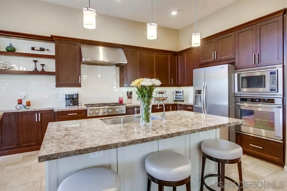 3396 Monique Lane Spring Valley, CA 91977 - Photo 14 of 51 a kitchen with stainless steel appliances granite countertop a sink refrigerator and microwave