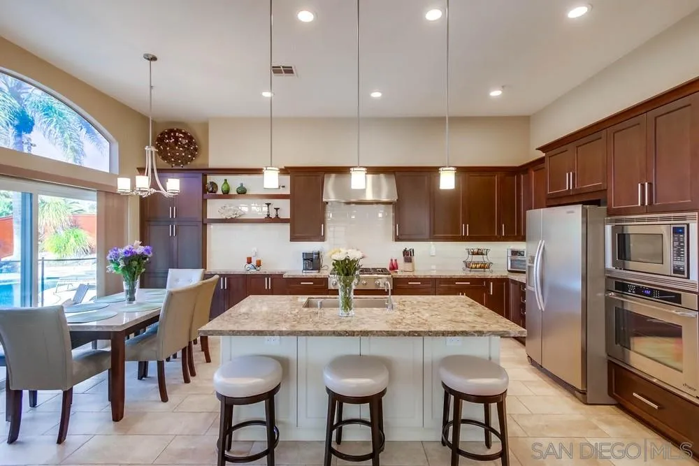 3396 Monique Lane Spring Valley, CA 91977 - Photo 15 of 51 a kitchen with granite countertop a dining table and chairs