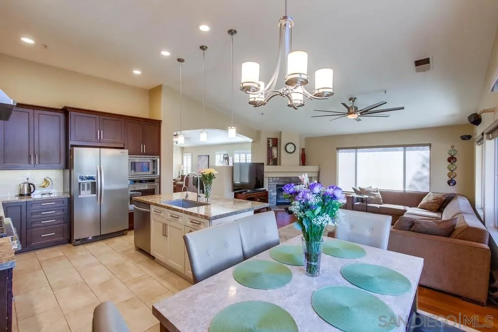 3396 Monique Lane Spring Valley, CA 91977 - Photo 22 of 51 a view of a dining room with furniture a kitchen and chandelier