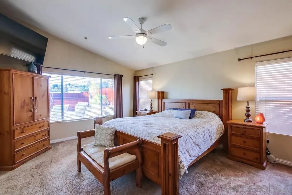 3396 Monique Lane Spring Valley, CA 91977 - Photo 24 of 51 a bedroom with a bed and a chandelier