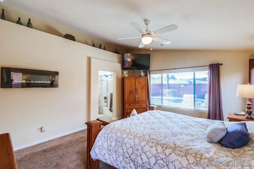 3396 Monique Lane Spring Valley, CA 91977 - Photo 25 of 51 a bedroom with a large bed and a large window