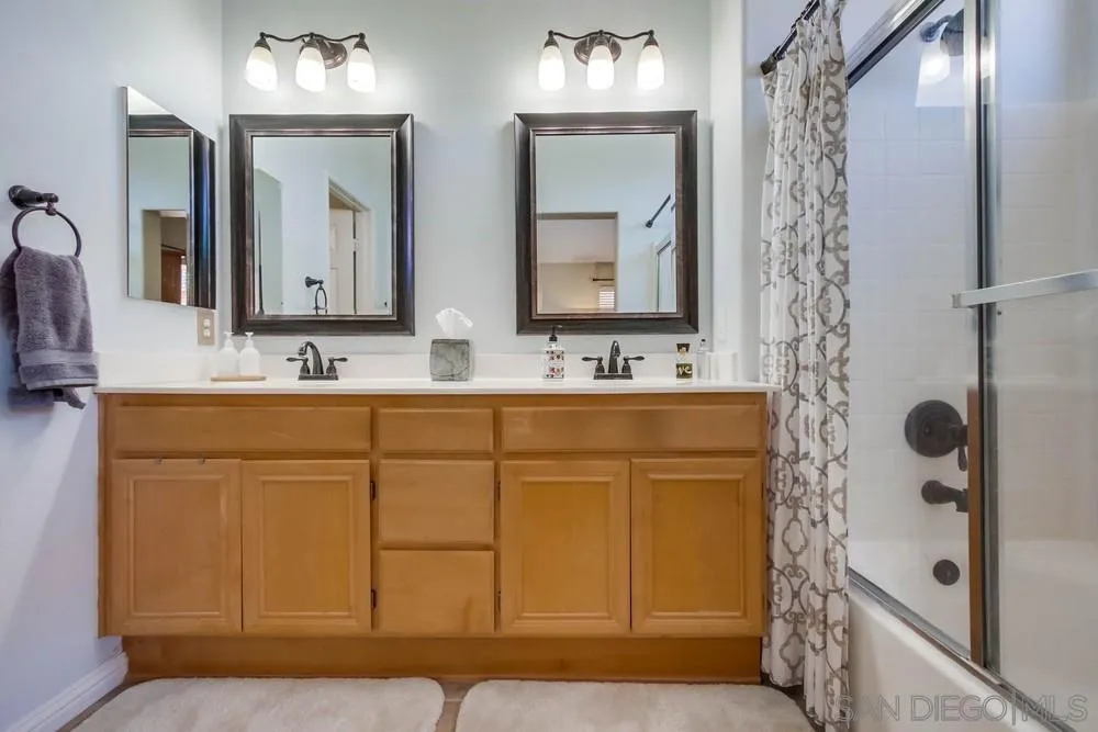 3396 Monique Lane Spring Valley, CA 91977 - Photo 28 of 51 a bathroom with a sink vanity and mirror