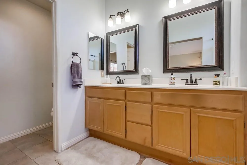 3396 Monique Lane Spring Valley, CA 91977 - Photo 29 of 51 a bathroom with 2 sink and a mirror