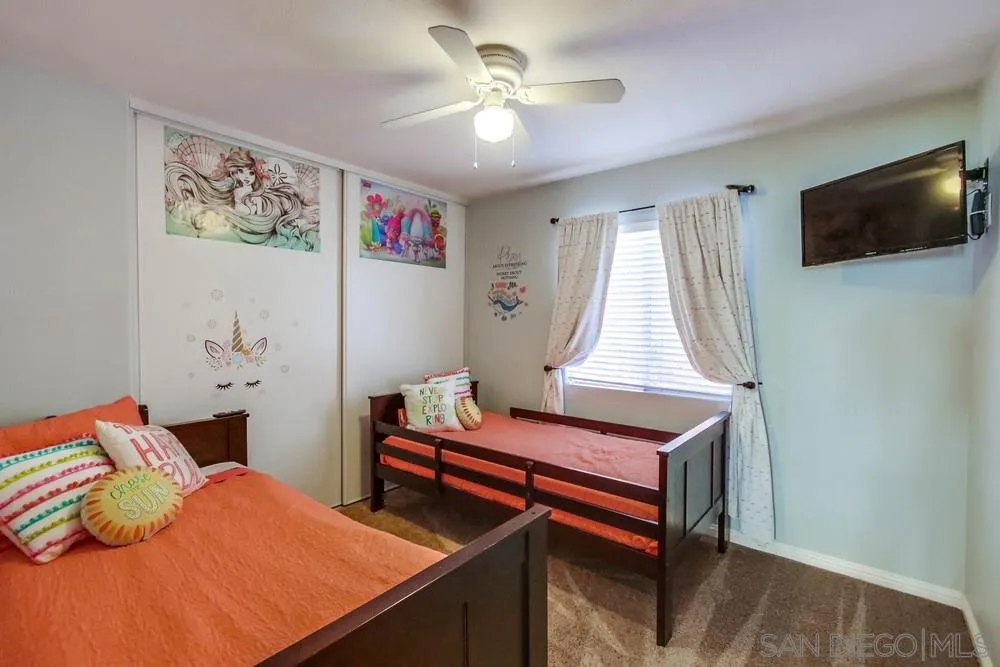 3396 Monique Lane Spring Valley, CA 91977 - Photo 35 of 51 a bedroom with a bed and a flat screen tv