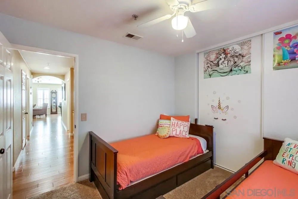 3396 Monique Lane Spring Valley, CA 91977 - Photo 36 of 51 a bedroom with a bed and a chandelier