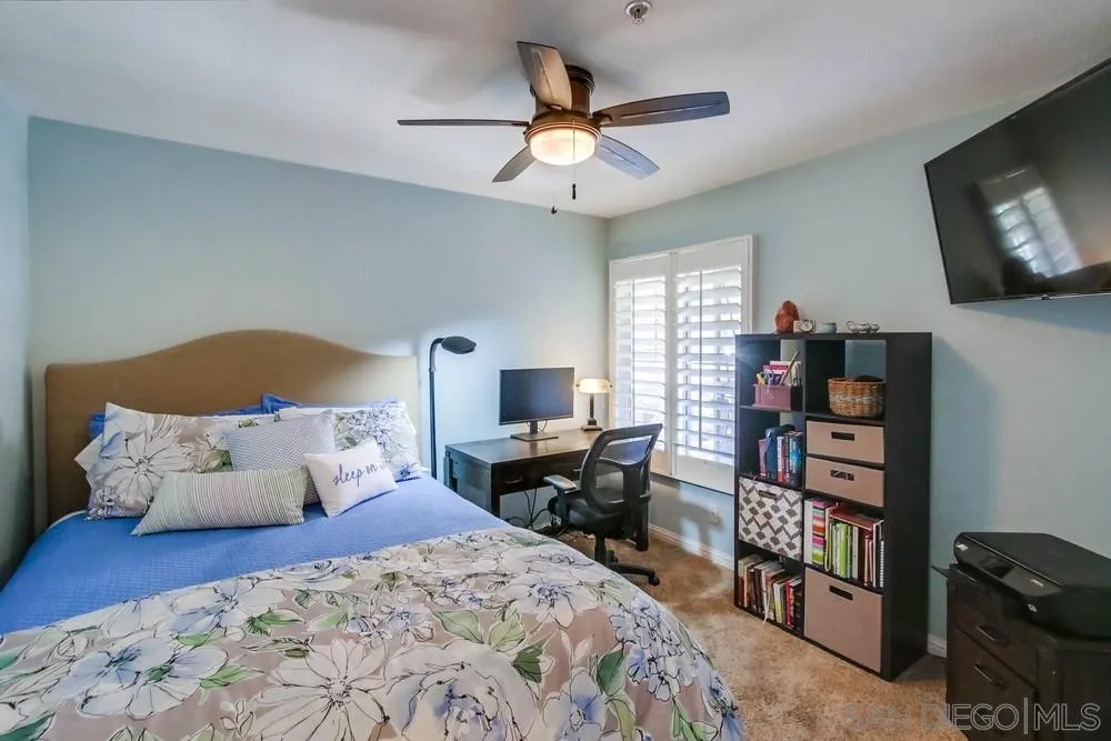 3396 Monique Lane Spring Valley, CA 91977 - Photo 37 of 51 a bedroom with bed and a chandelier