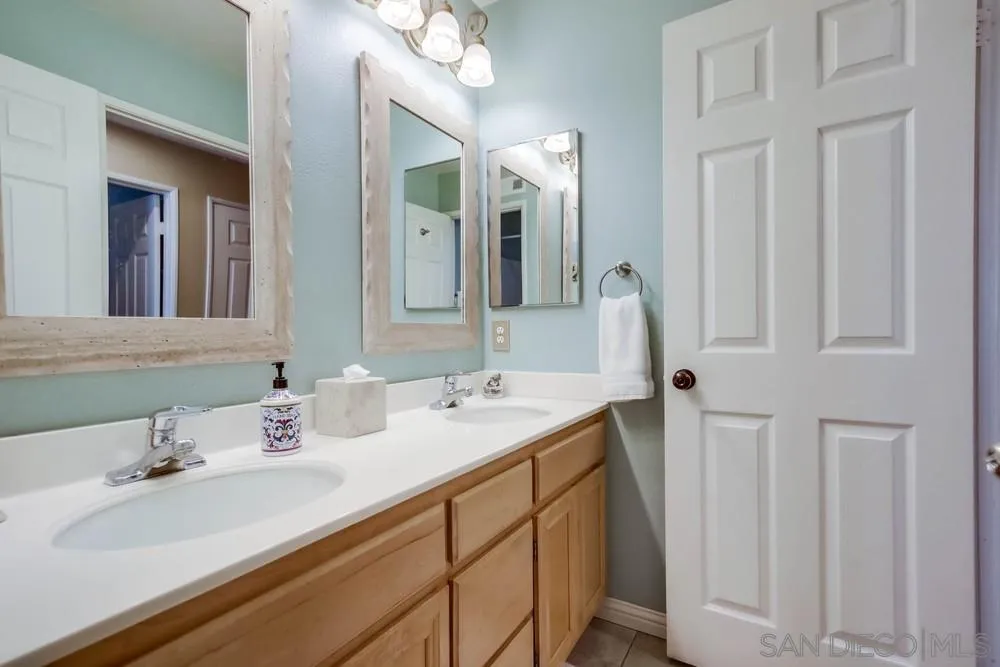 3396 Monique Lane Spring Valley, CA 91977 - Photo 40 of 51 a bathroom with a double vanity sink and a mirror