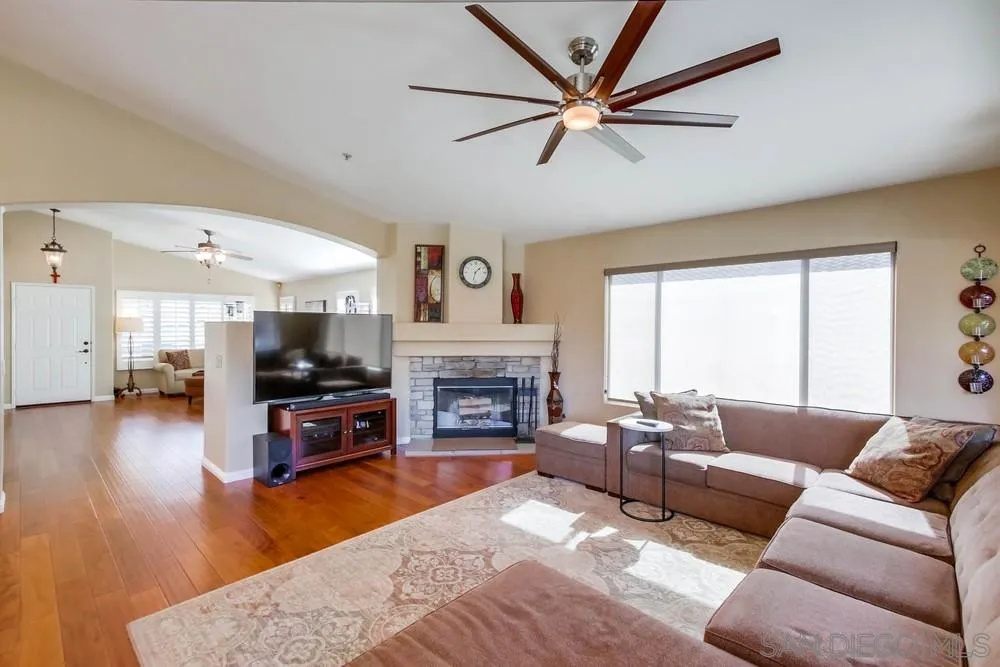 3396 Monique Lane Spring Valley, CA 91977 - Photo 10 of 51 a living room with furniture a fireplace and a flat screen tv