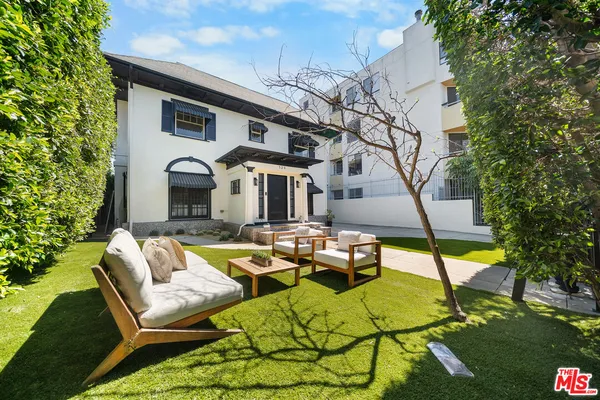 a front view of a house with garden and patio