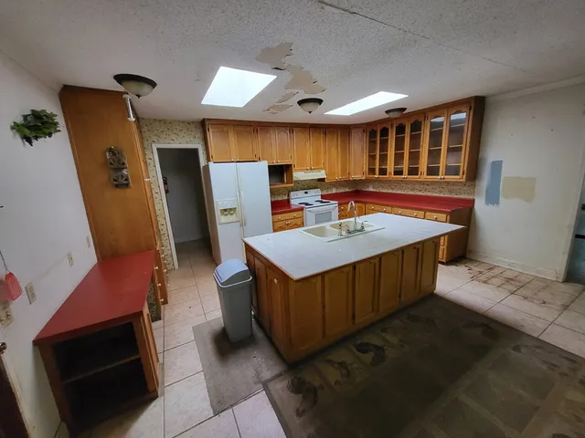 a room with wooden cabinets and stainless steel appliances