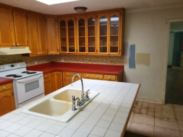 a kitchen with a sink and a stove top oven