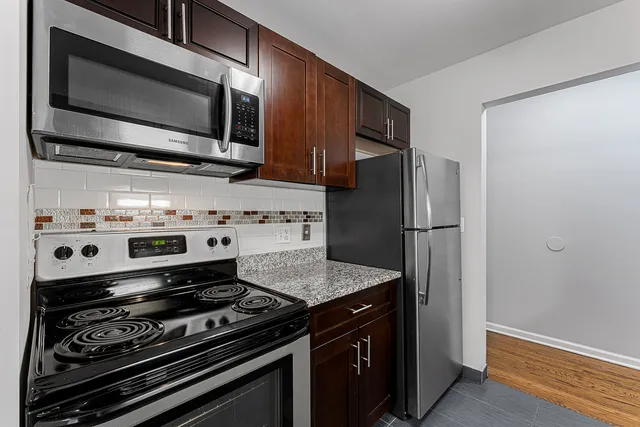 a kitchen with a stove microwave and refrigerator