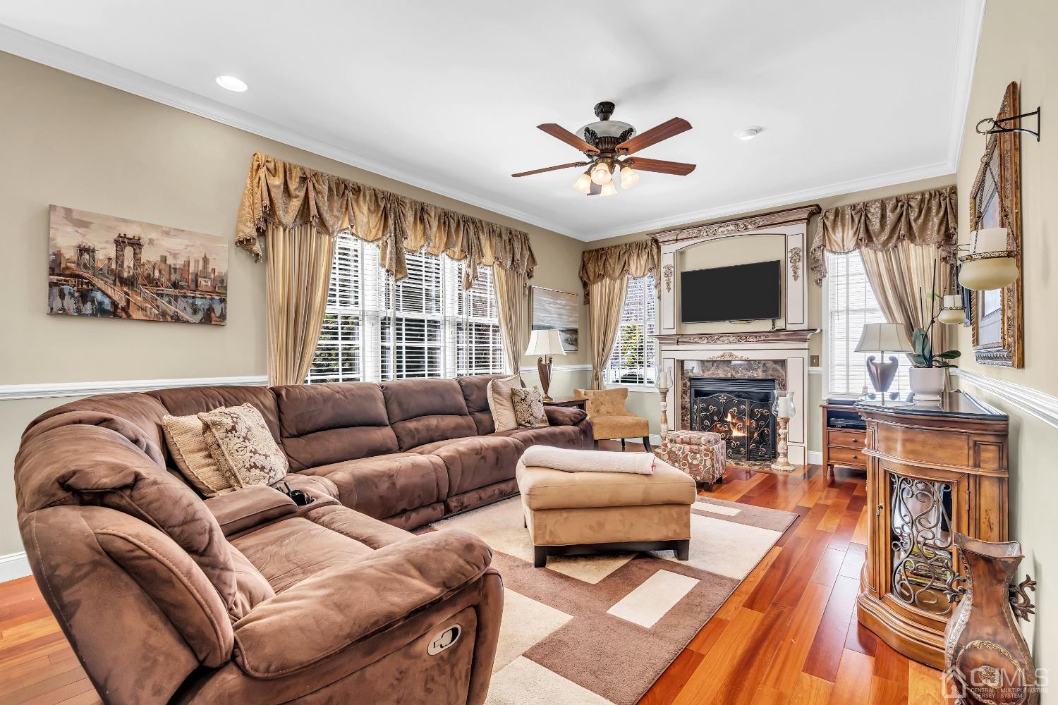 58 Stratton Road Old Bridge, NJ 07747 - Photo 17 of 44 a living room with furniture a fireplace and a flat screen tv