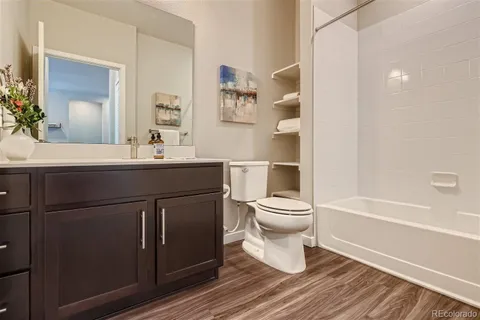 a bathroom with a sink toilet a mirror and shower