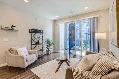 a living room with furniture and a floor to ceiling window