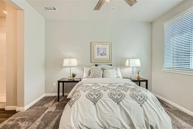 a bedroom with a bed and a lamp