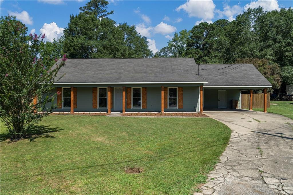 766 Lee Road Phenix City, AL 36870 - Photo 1 of 30 View of front facade with driveway, a carport, a front yard, and a porch