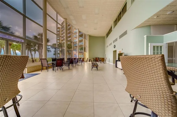 a patio with couches and dining table