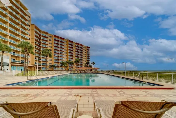 a view of swimming pool with outdoor seating and city view
