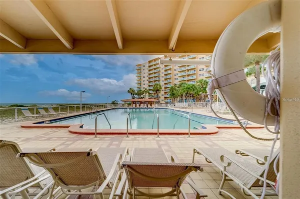 a view of swimming pool with outdoor seating