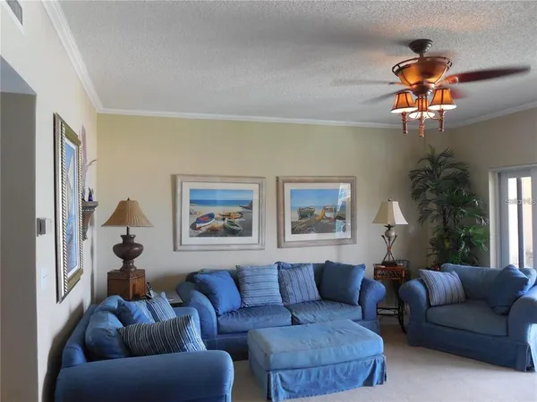 a living room with furniture a chandelier and a window