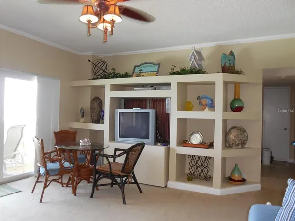 a dining room with a wooden table and chairs