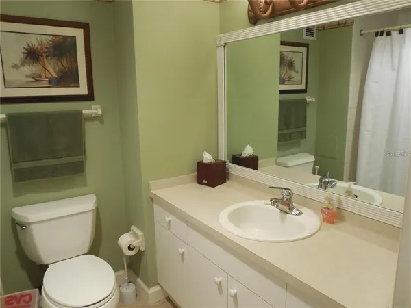 a bathroom with a sink mirror and toilet
