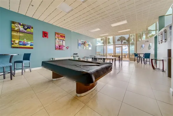 a living room with lots of furniture and view of kitchen