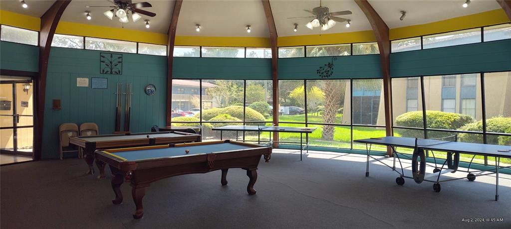 2811 Southwest Archer Road, Unit F46 Gainesville, FL 32608 - Photo 14 of 17 a room with pool table and windows