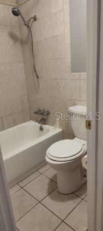 2811 Southwest Archer Road, Unit F46 Gainesville, FL 32608 - Photo 10 of 17 a bathroom with a toilet and a bath tub