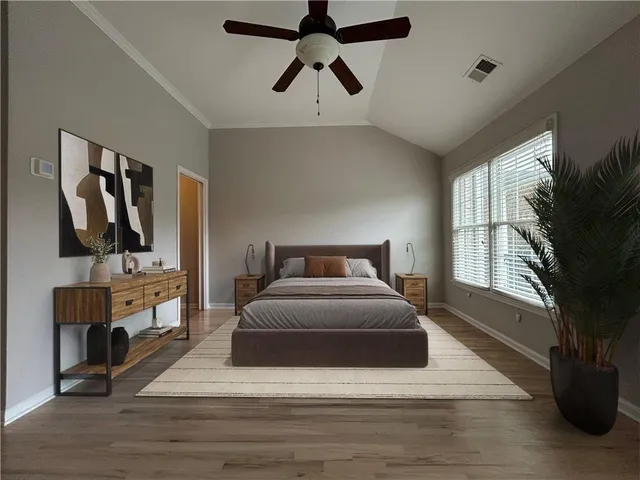 a spacious bedroom with a large bed a flat tv screen and a dresser