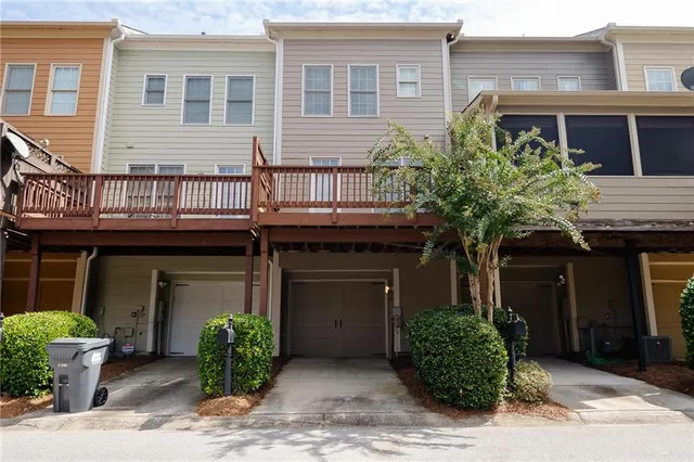 a sign that is sitting in front of a brick wall