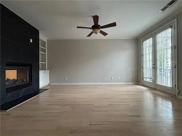 a view of an empty room with a fireplace and a window