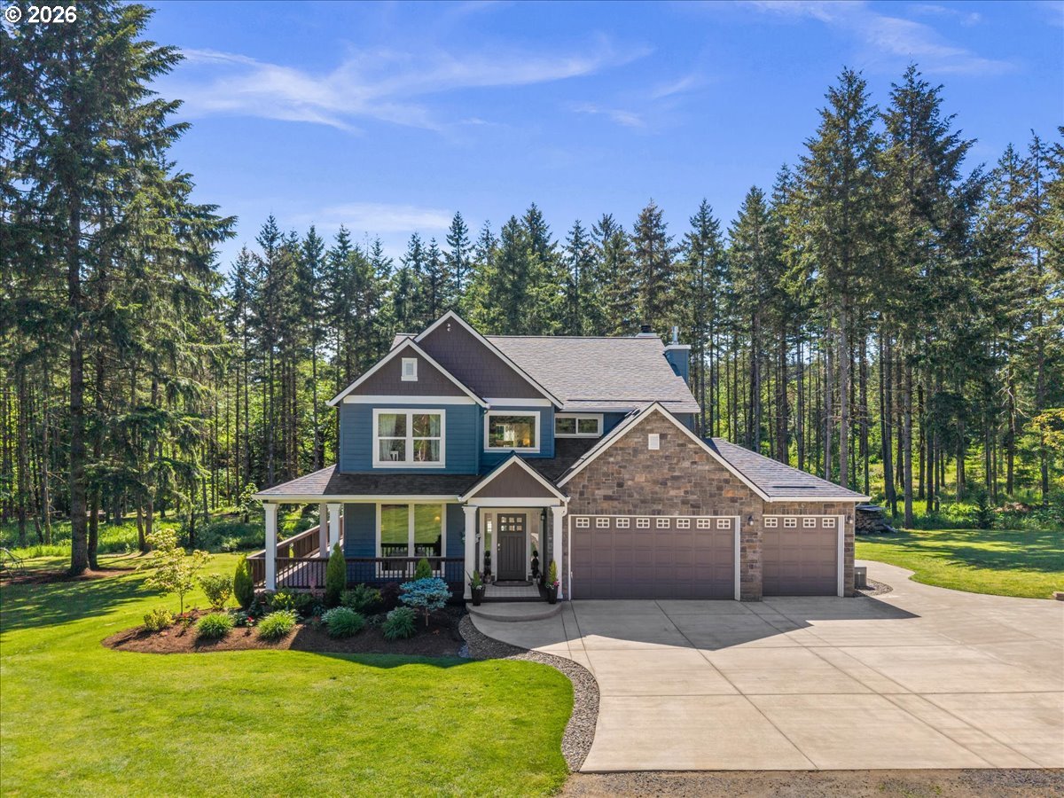 a view of a house with a big yard and large trees