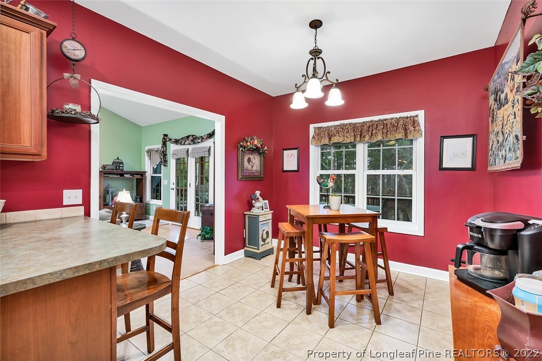 145 Covenant Road Carthage, NC 28327 - Photo 12 of 42 a view of a dining room with furniture and chandelier