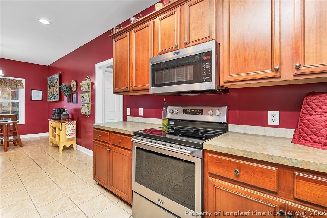 145 Covenant Road Carthage, NC 28327 - Photo 8 of 42 a kitchen with stainless steel appliances granite countertop a stove a sink and a microwave