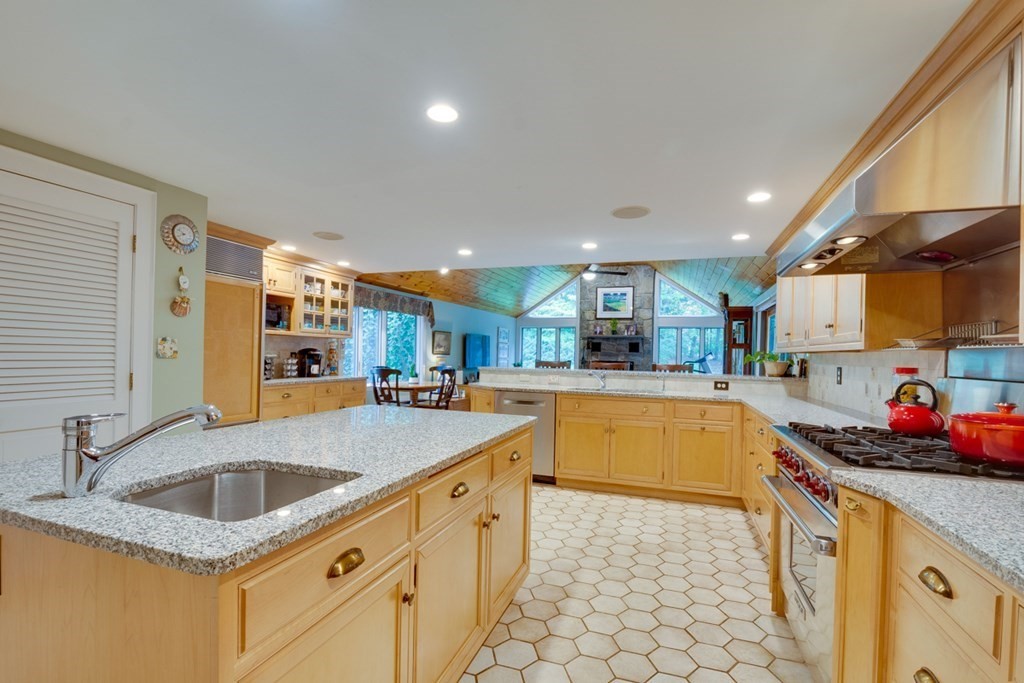 29 Sheridan Road Wellesley, MA 02481 - Photo 11 of 32 a kitchen with stainless steel appliances granite countertop a sink stove and cabinets
