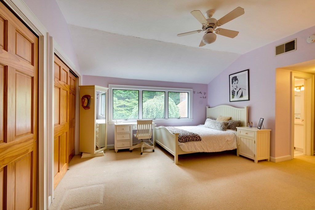 29 Sheridan Road Wellesley, MA 02481 - Photo 16 of 32 a bedroom with a bed and a chandelier