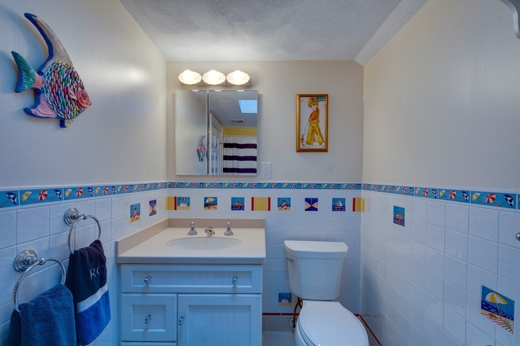 29 Sheridan Road Wellesley, MA 02481 - Photo 18 of 32 a bathroom with a sink vanity mirror and toilet