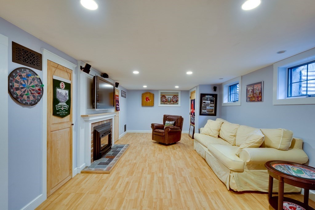 29 Sheridan Road Wellesley, MA 02481 - Photo 25 of 32 a living room with furniture and a fireplace