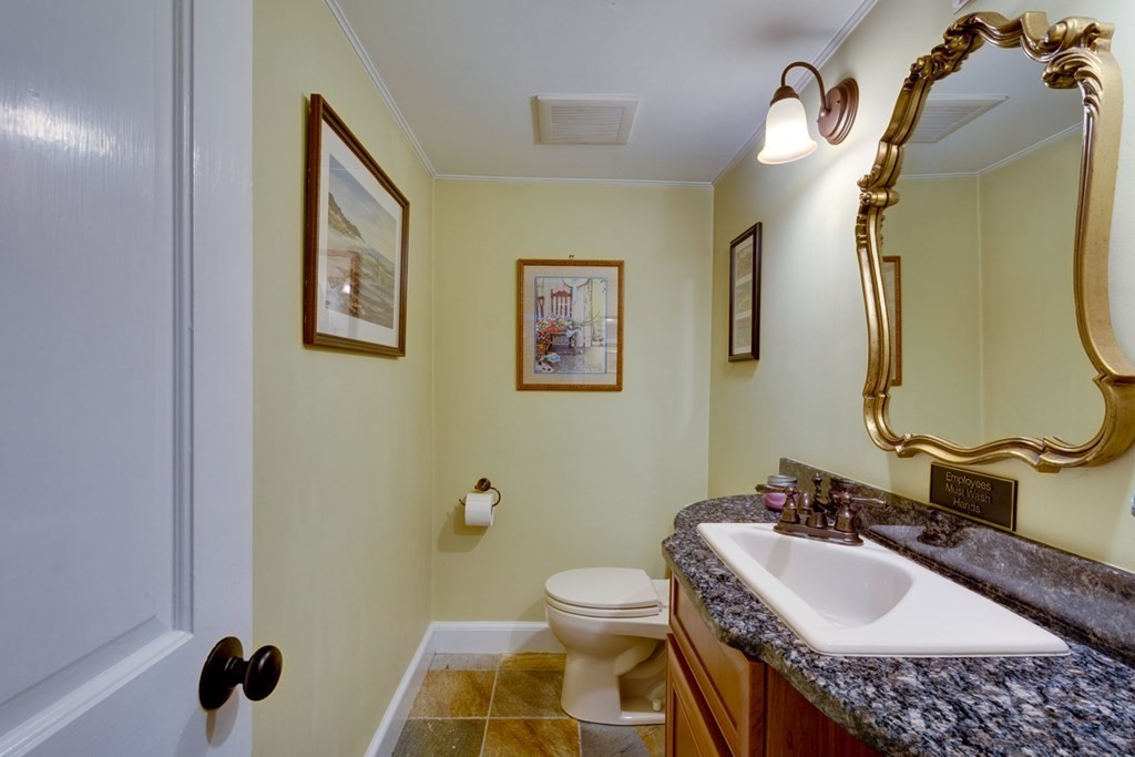 29 Sheridan Road Wellesley, MA 02481 - Photo 10 of 32 a bathroom with a granite countertop sink and a mirror
