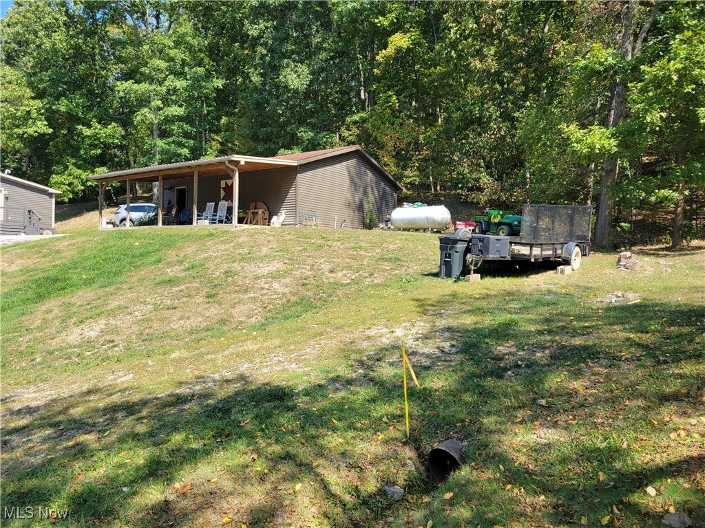 85645 Merryman Road Cadiz, OH 43907 - Photo 23 of 38 View of yard and garage with carport/patio