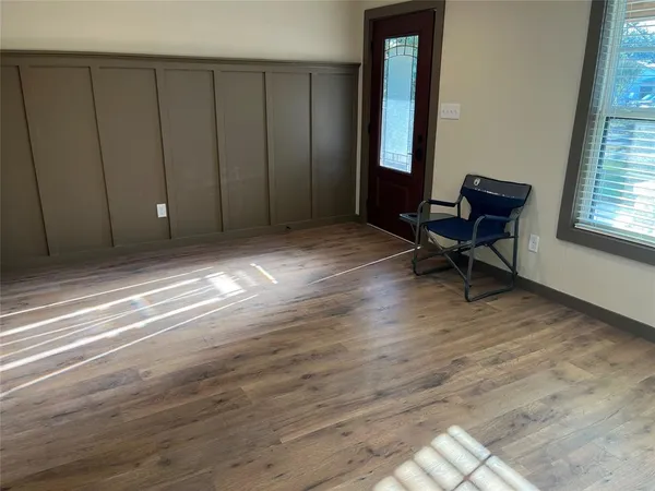 a view of wooden floor and windows in a room
