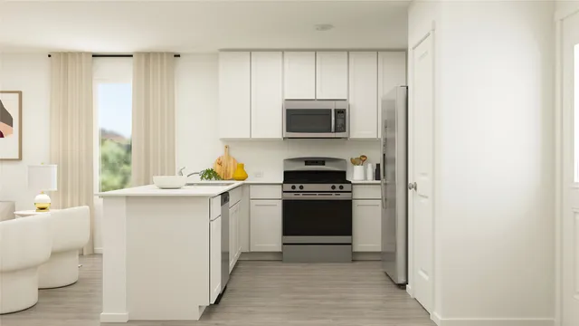 a kitchen with stainless steel appliances a stove a sink and a refrigerator